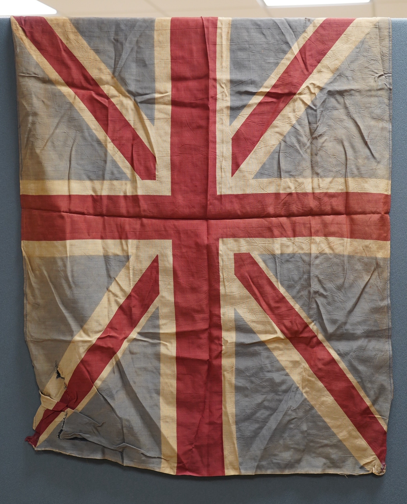 Eight mostly mid 20th century Union Jack flags, one celebrating Queen Victoria’s Diamond Jubilee, together with a Saint George’s cross and a string of Union flag bunting. Condition - poor to good